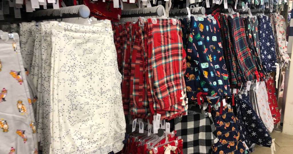 pairs of pajama bottoms hanging up in store