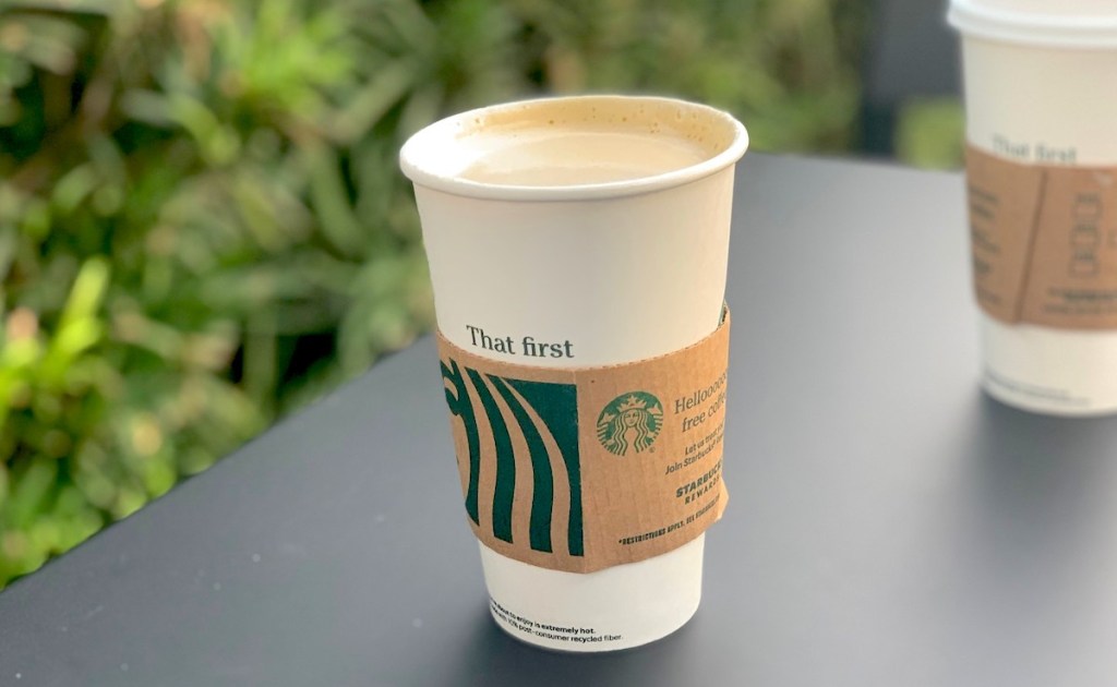 pumpkin chai drink sitting in starbucks cup on table outside