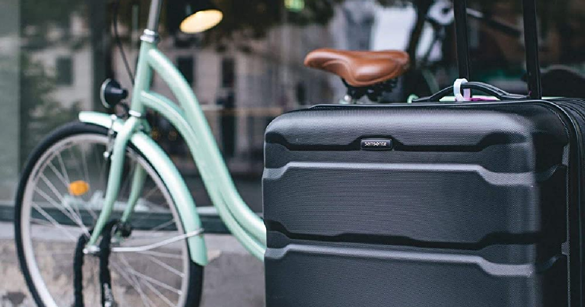 samsonite luggage outside with bike behind it