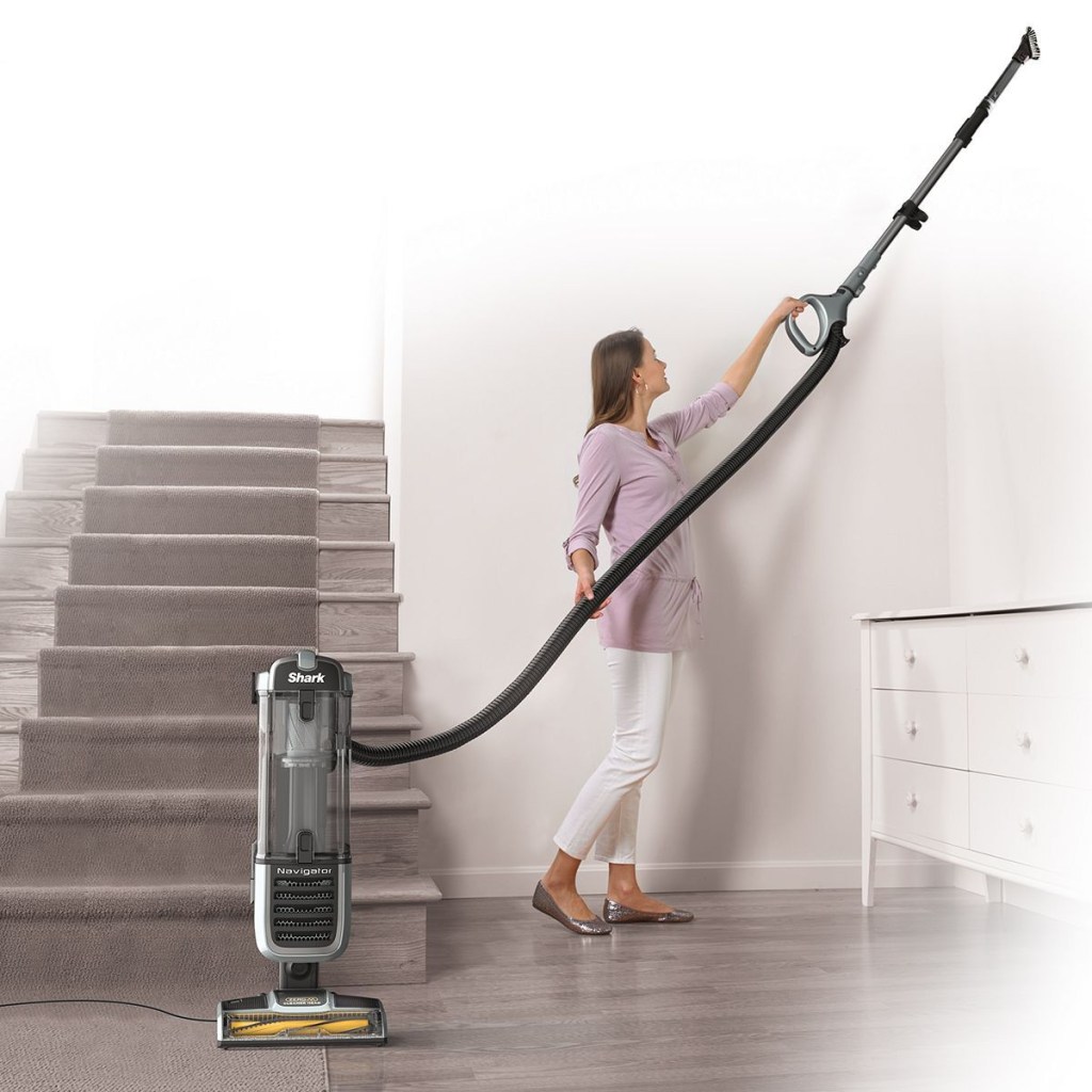 women cleaning ceiling with vacuum