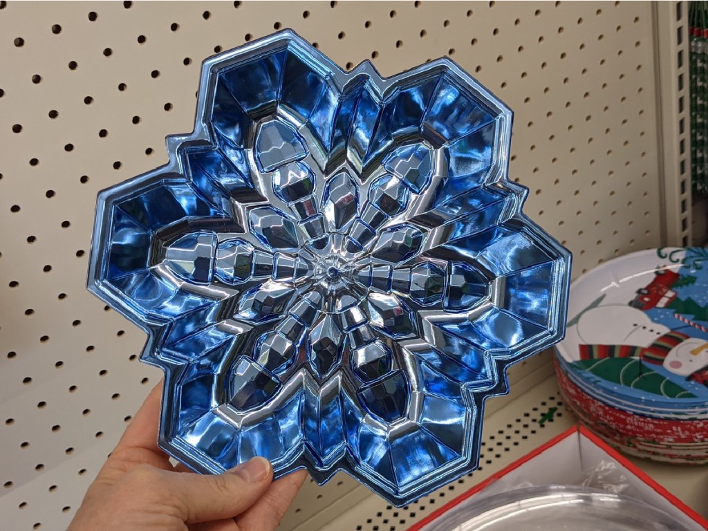 hand holding blue tray shaped like snowflake