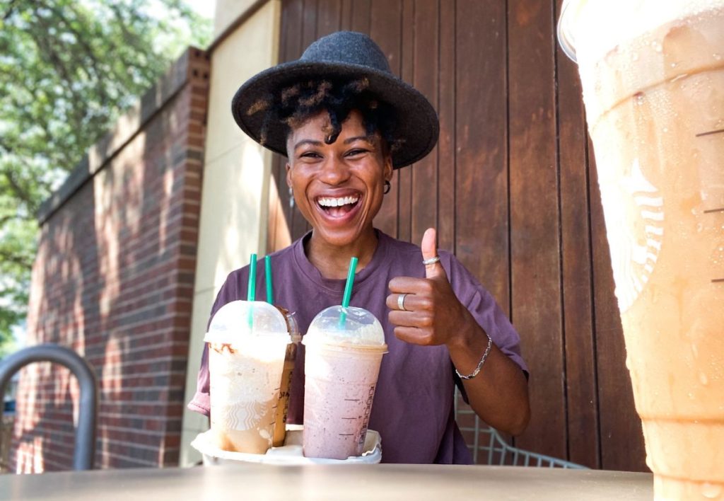 woman holding tray of starbucks