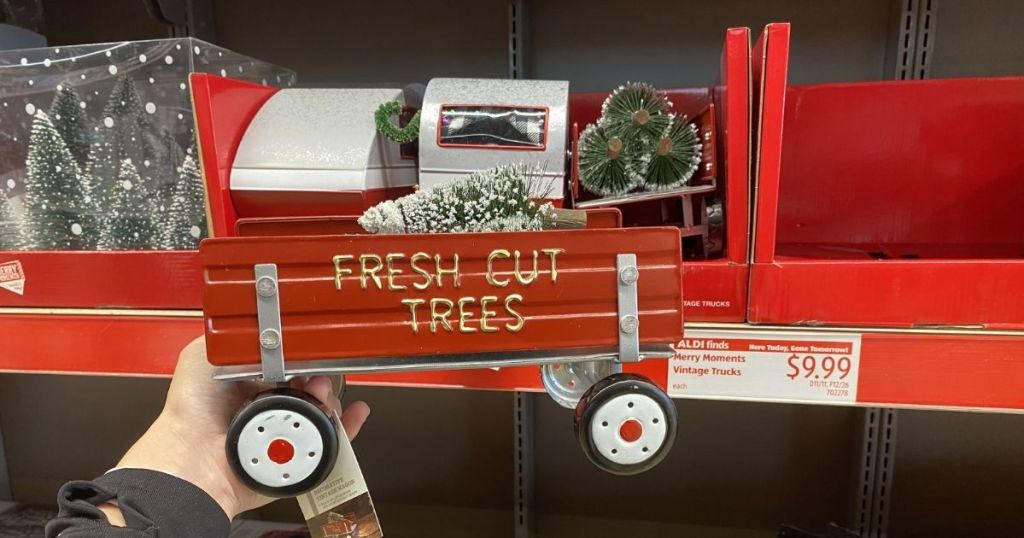 hand holding Christmas decor red wagon 