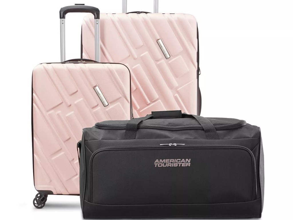 two pink suitcases and black duffel bag