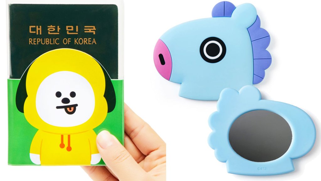 person holding up a passport with a yellow dog character cover and a blue horse shaped hand mirror