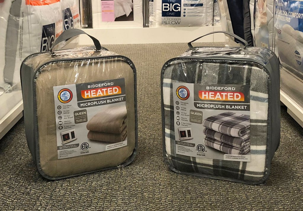 two biddeford heated blankets in clear packages on floor at kohl's