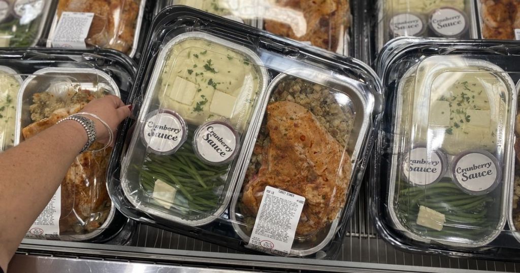 WOman's hand holding a Costco Thanksgiving Food Bundle