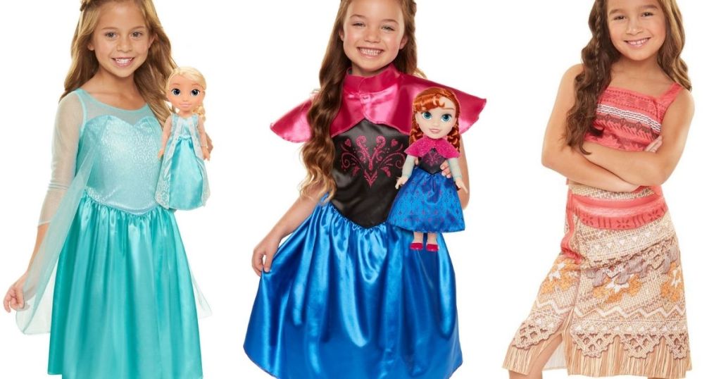 girls wearing Disney Princess dresses and a doll