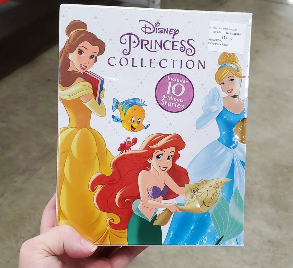 woman holding up disney princess collection book set at sam's club