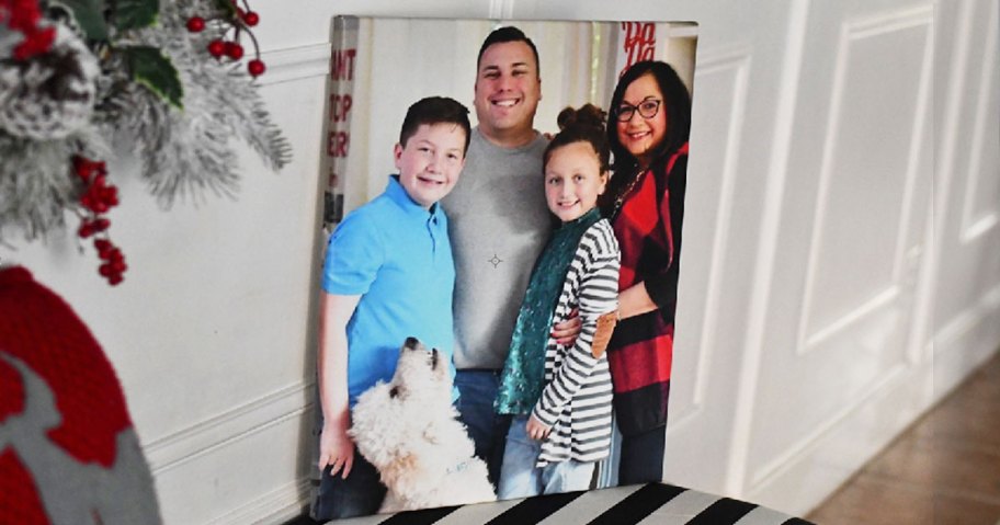 photo canvas of a family with dog sitting on a white and black bench