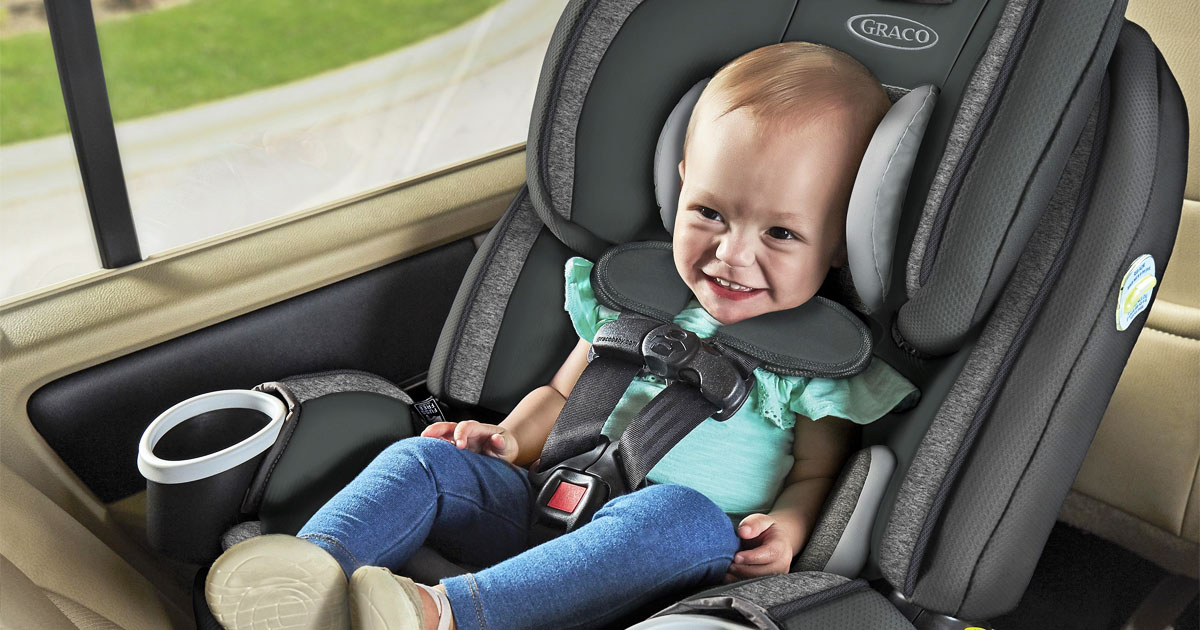 baby sitting in a grey and black graco car seat