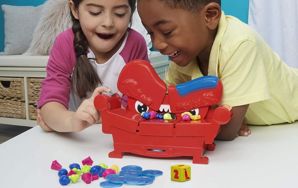 kids sitting behind a toy couch