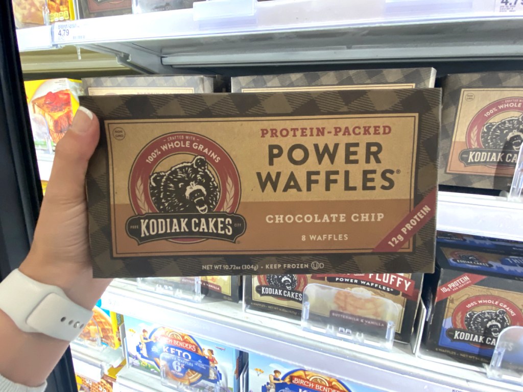 woman's hand holding a box of kodiak cakes in store at target 