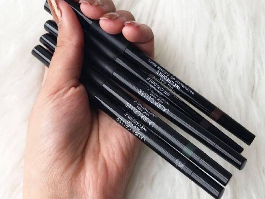 hand holding tubes of eyeliner