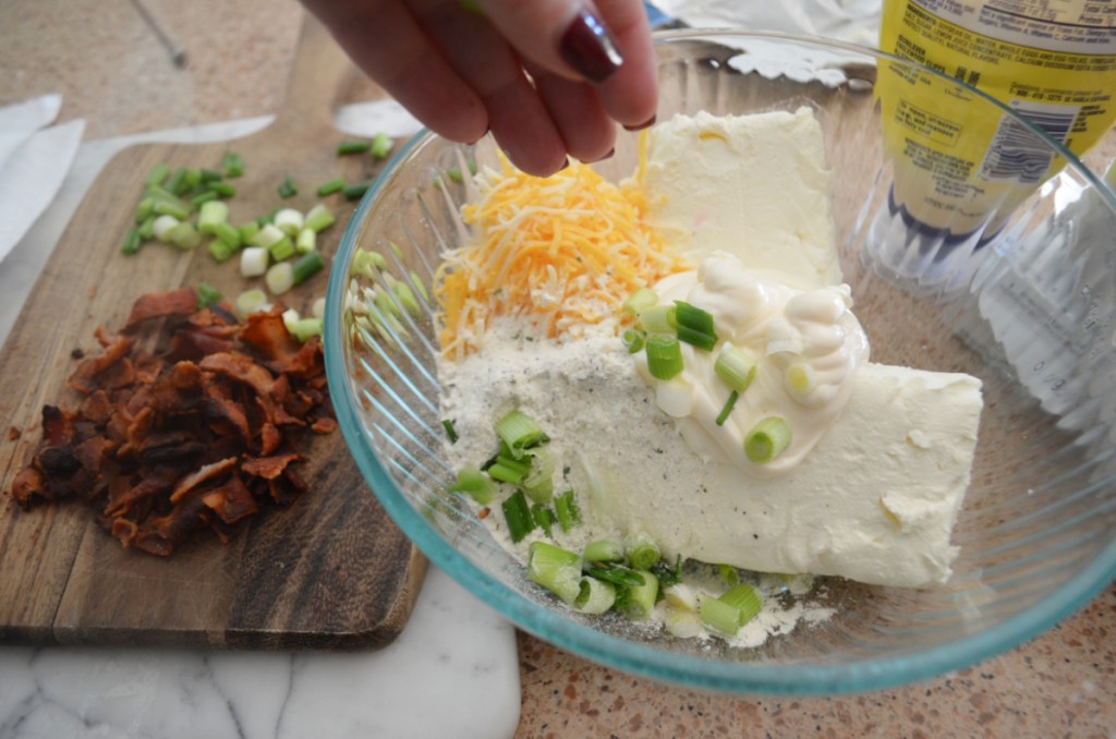 Preparing a cheese ball appetizer for a holiday party