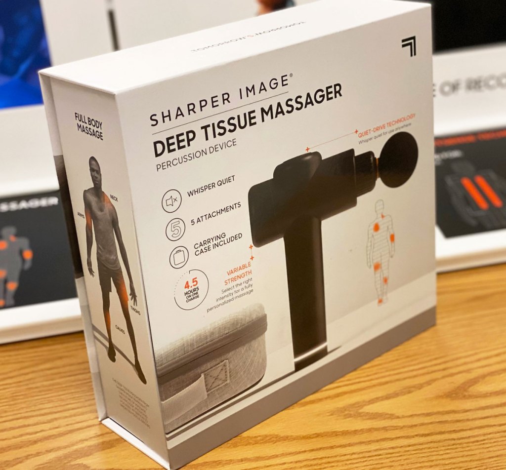 sharper image massage gun in box on a wood display table at kohl's