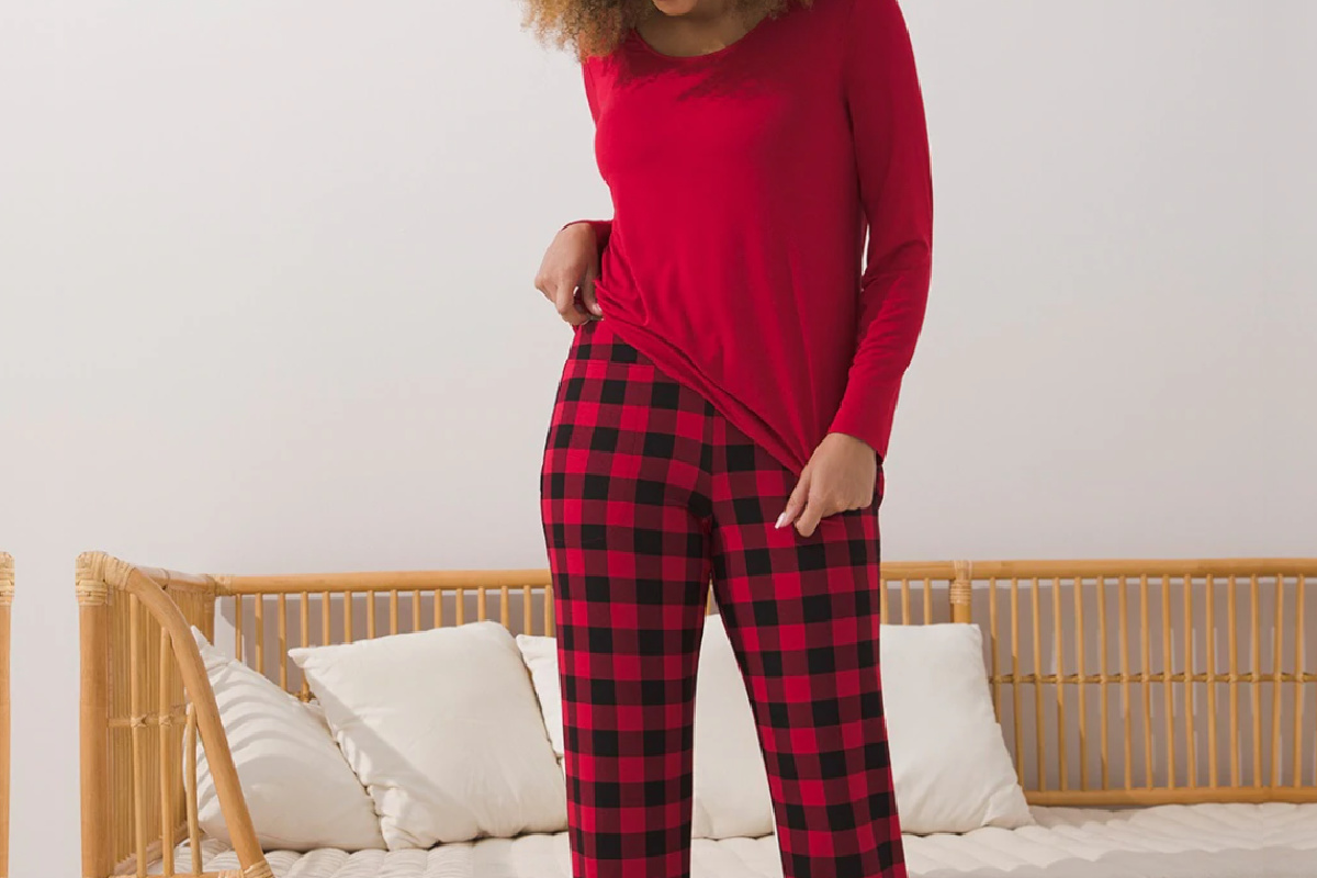 woman standing wearing buffalo plaid pajamas