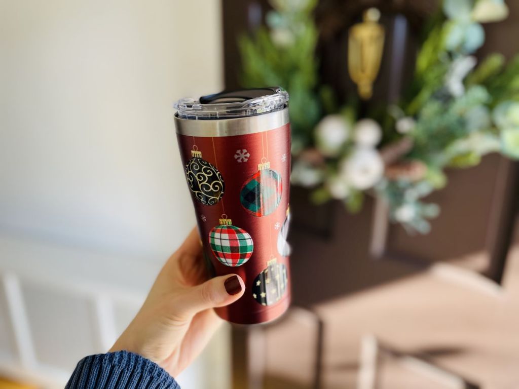 hand holding a Tervis tumbler