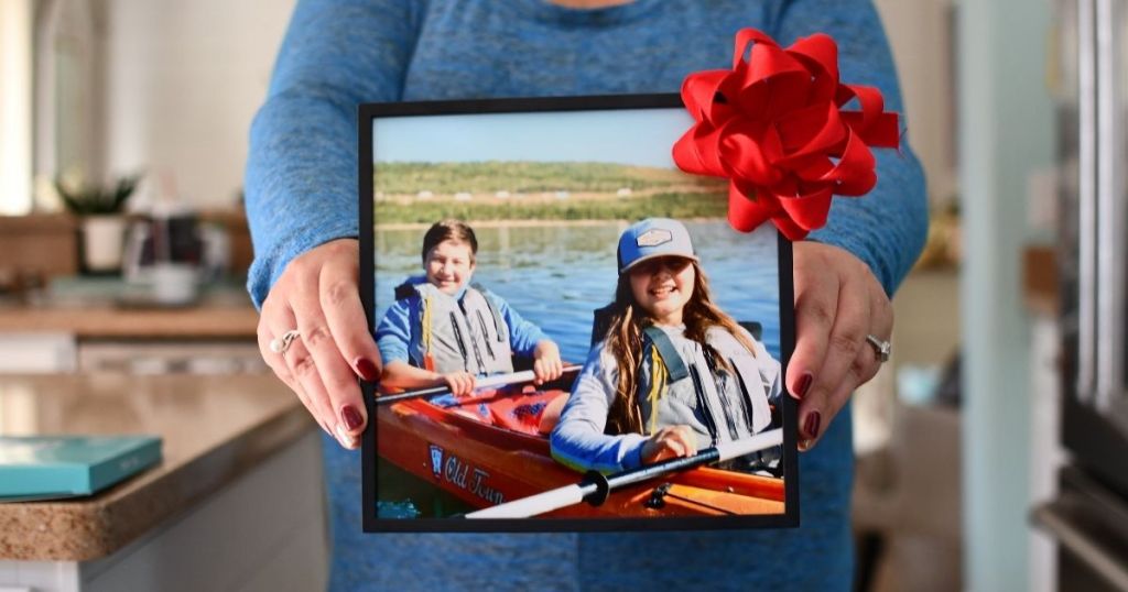 woman holding a framed picture