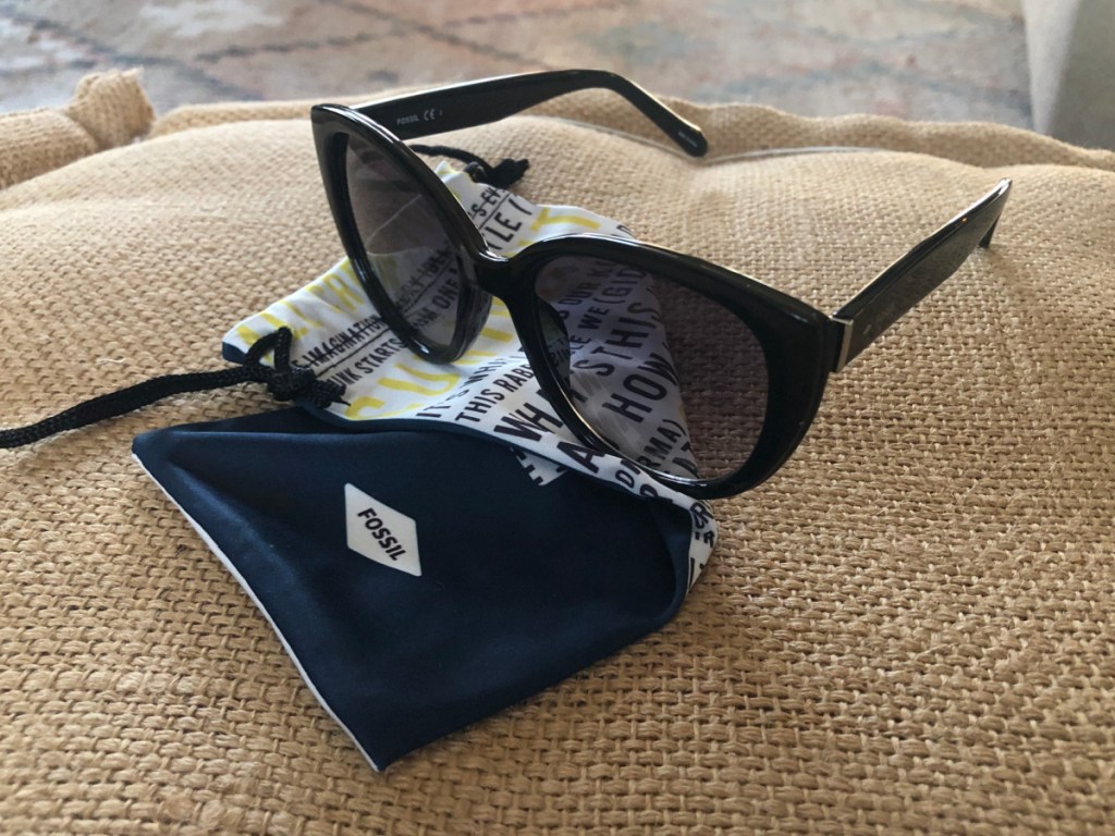 women's fossil sunglasses sitting on top of a fossil dust bag