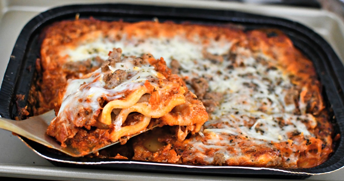 Spatula dishing up a Costco frozen lasagna for low effort meal ideas. 