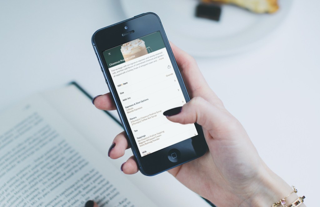 hand holding phone with gingerbread latte secret menu drink on screen