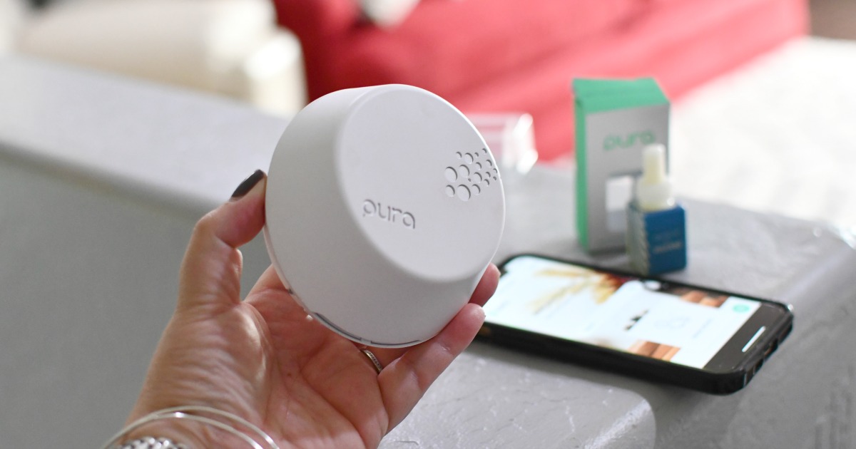 holding a pura smart diffuser