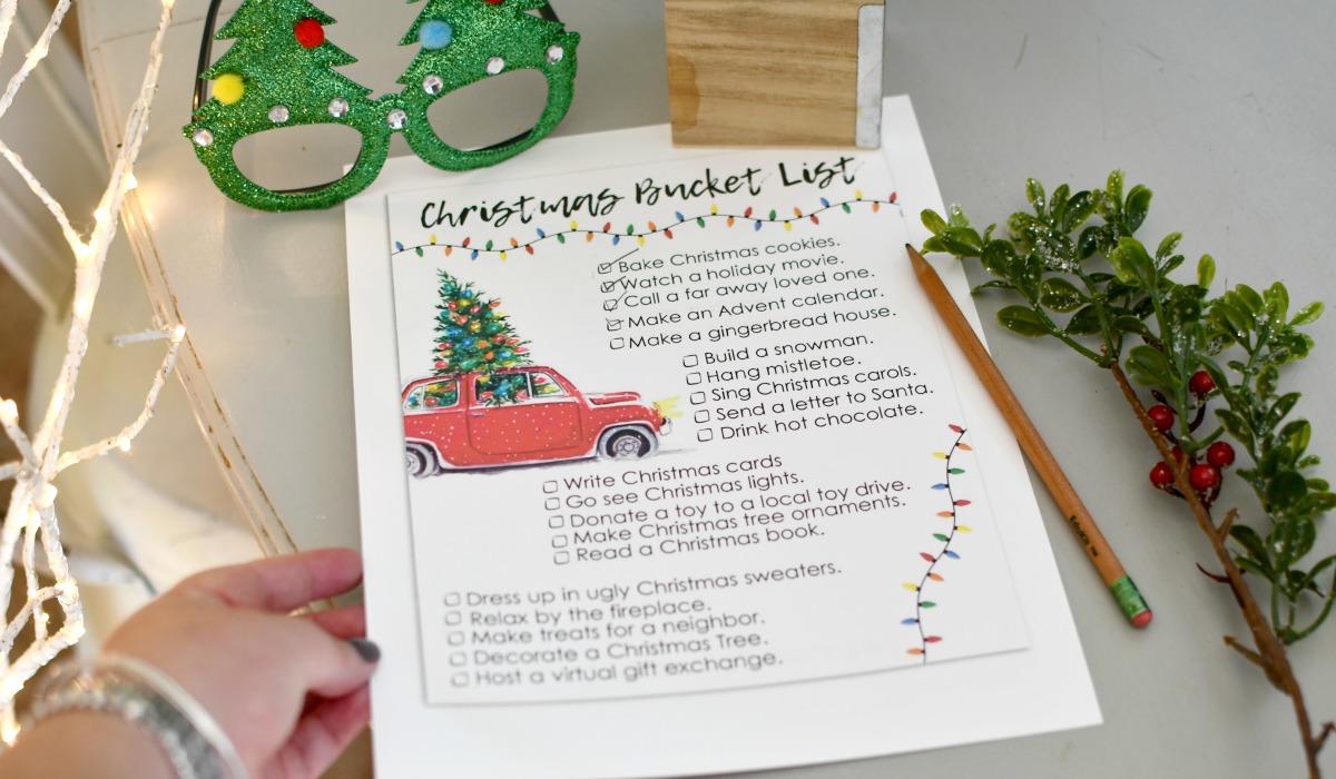 holding free printable christmas bucket list