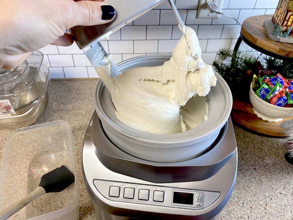 hand holding top of ice cream maker mixer