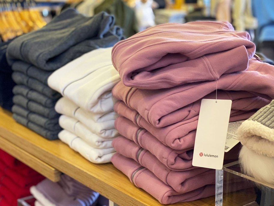 stacks of folded sweatshirts on display