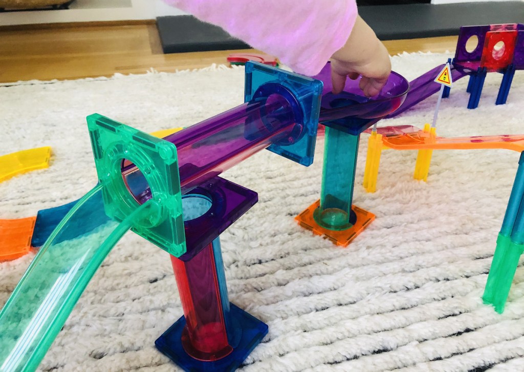 toddler playing with marble maze set