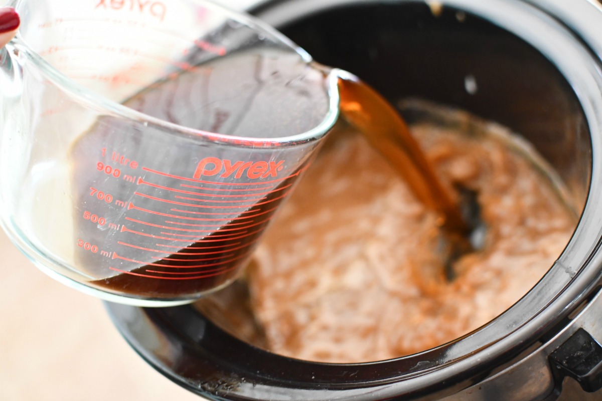 pouring coffee into slow cooker