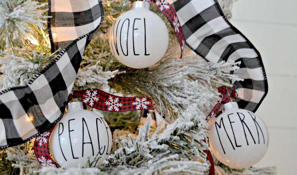 rae dunn ornaments hanging on flocked christmas tree