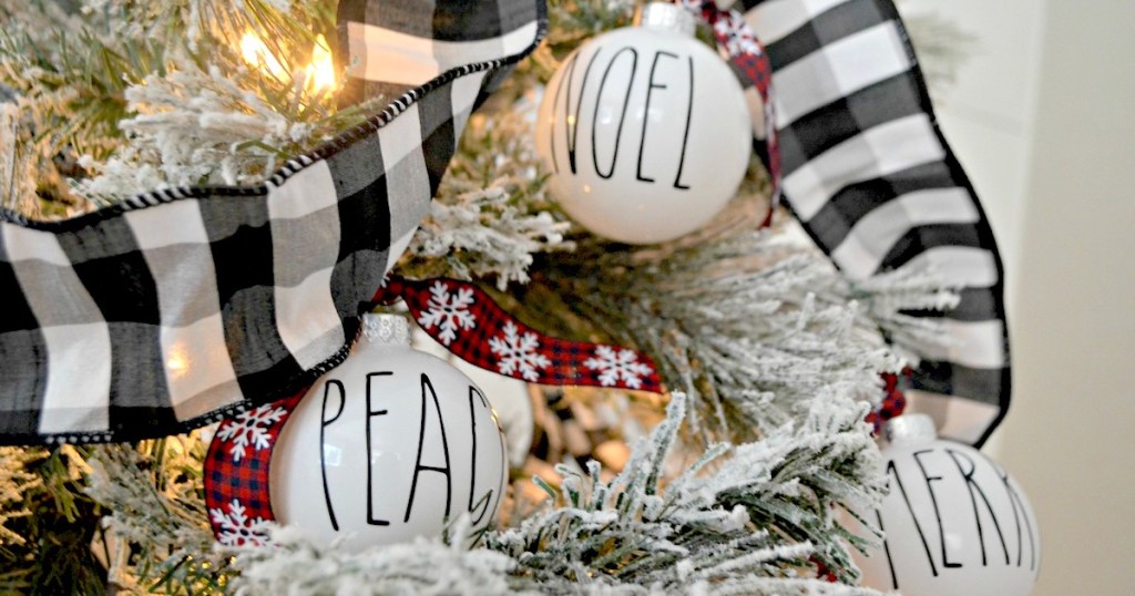 hanging christmas ornaments on tree