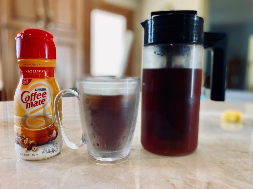 coffee maker, with cup and creamer on counter