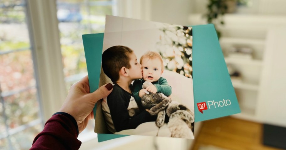 woman holding walgreens photo print and envelope