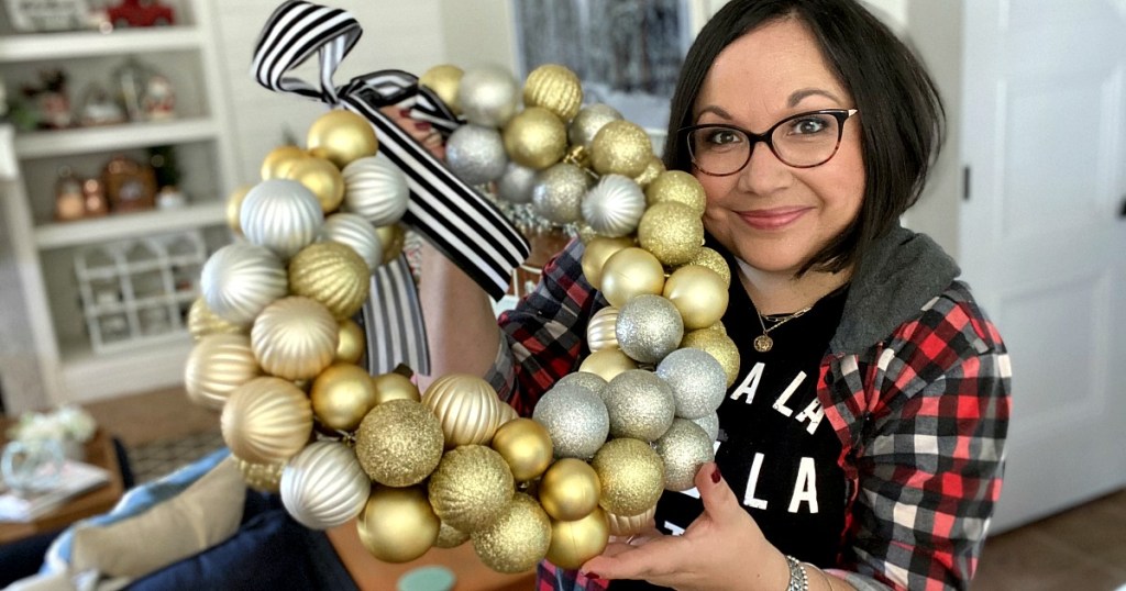 woman holding an ornament wreath