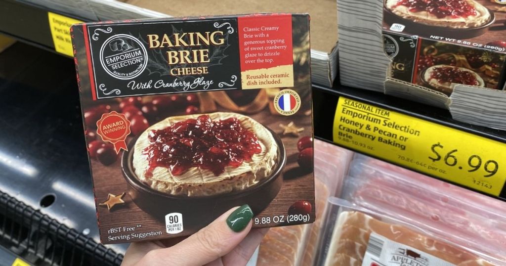 hand holding package of baking brie