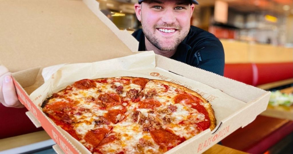 man holding a pizza