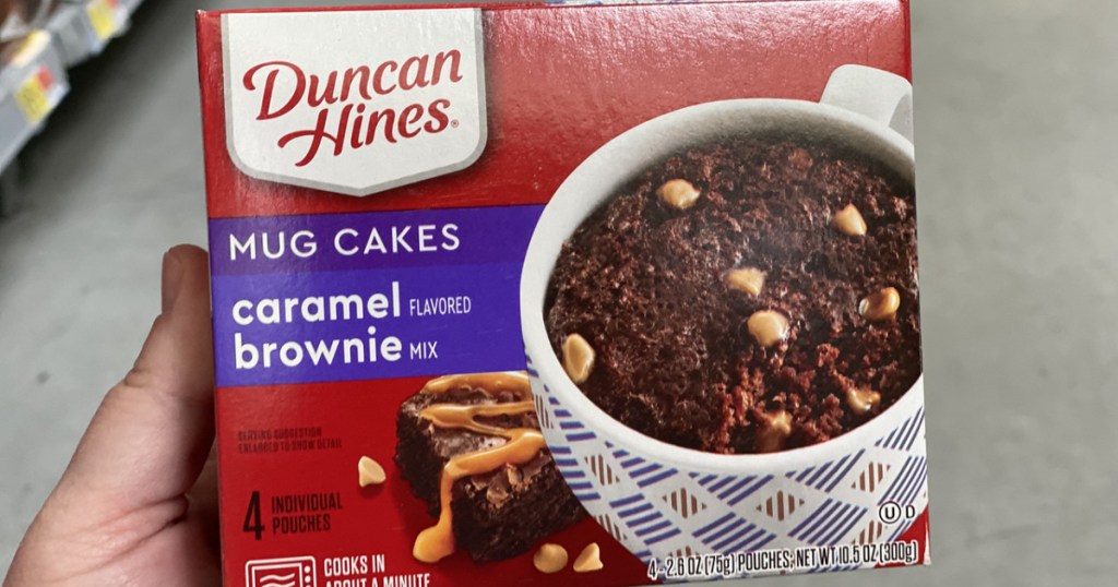 hand holding box of caramel brownie mug mix