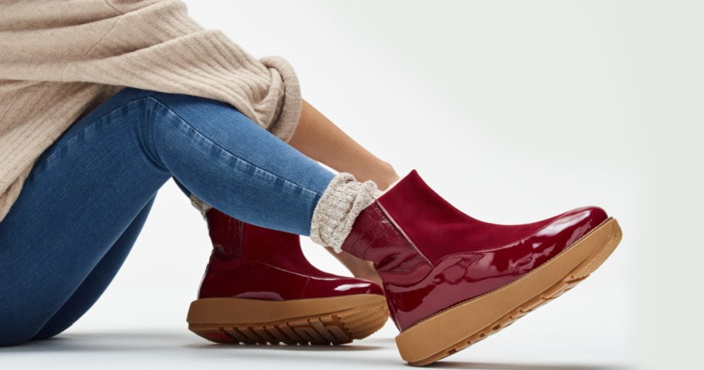 woman wearing maroon colored fitflop boots