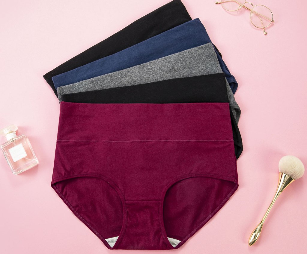 five pairs of women's high-waisted panties in jewel tones on a pink background