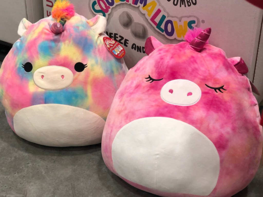 2 jumbo squishmallows sitting on the floor at Costco