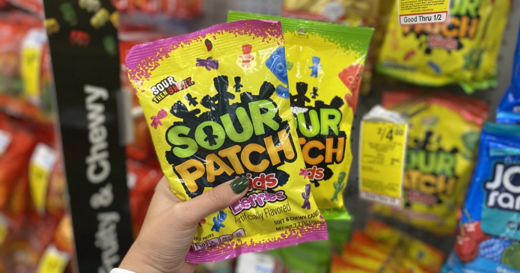 woman's holding two bags of candy in store