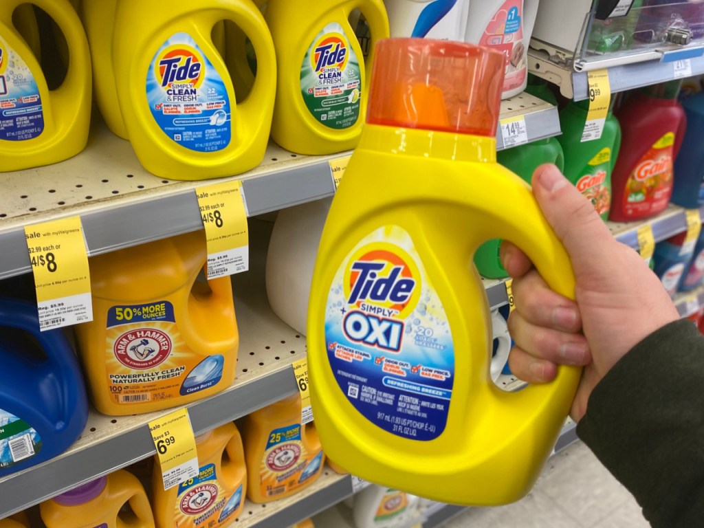 hand holding tide simply detergent in walgreens