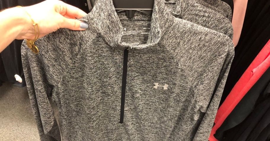 hand holding an Under Armour pullover