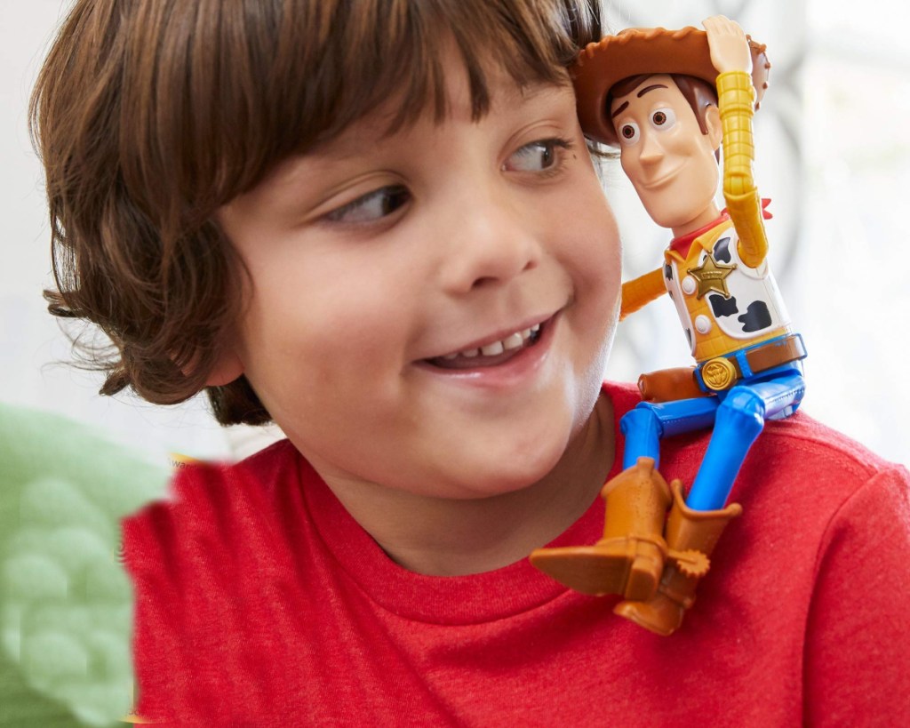 disney woody figure sitting on boys shoulder