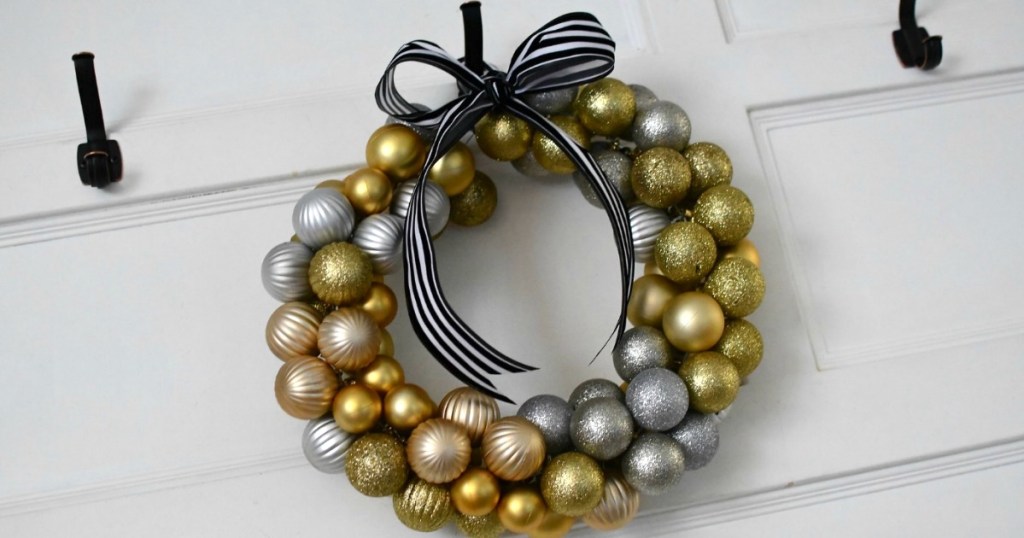 Christmas wreath with gold ornaments hanging 