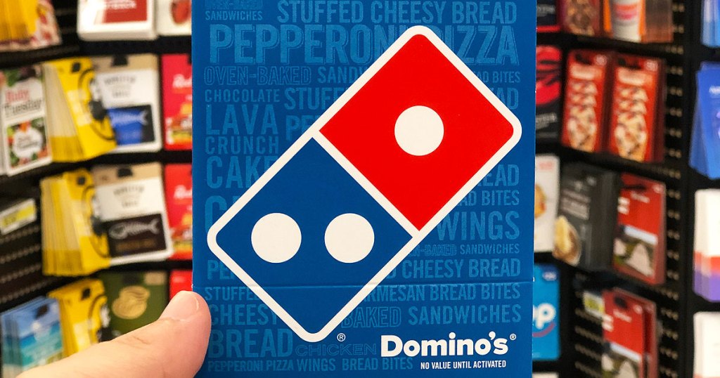 person holding up a blue and red dominos pizza gift card