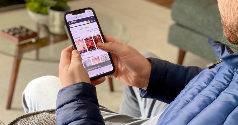 man using kindle on phone